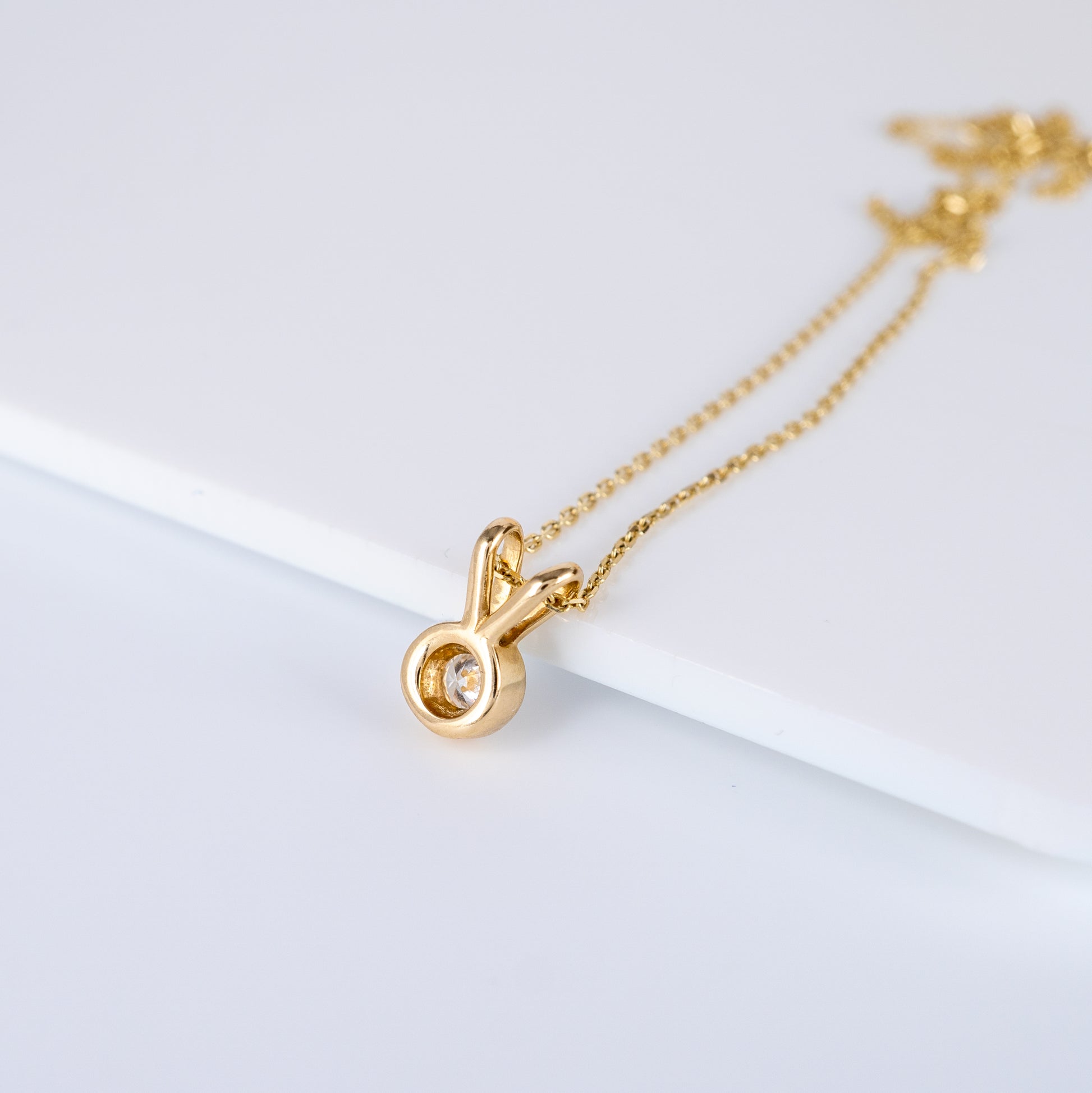 Reverse view of 9ct yellow gold diamond V bale pendant necklace, showcasing the setting and hallmarks
