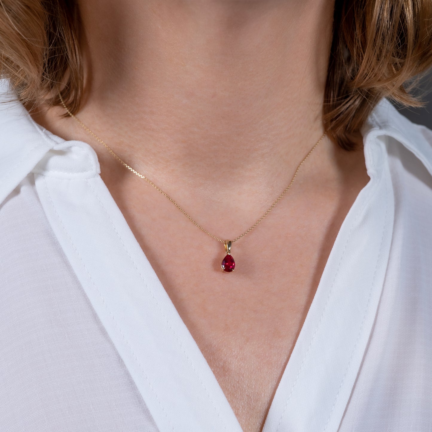 Ruby Teardrop Pendant Necklace 9ct Yellow Gold worn on womans neck - Hunters Fine Jewellery