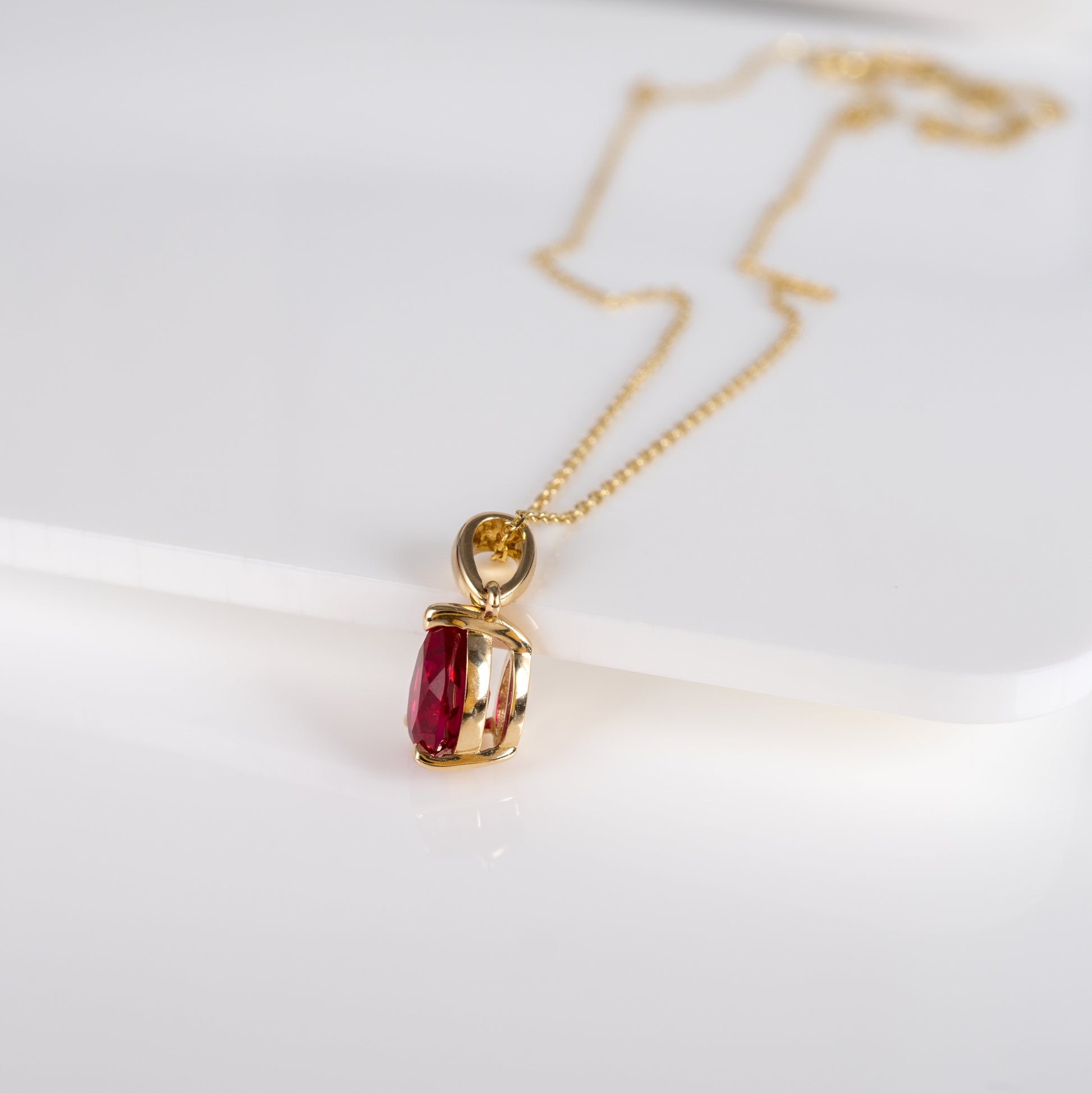 Ruby teardrop pendant in 9ct yellow gold, featuring lab-grown ruby with pear-shaped design by Hunters Fine Jewellery.