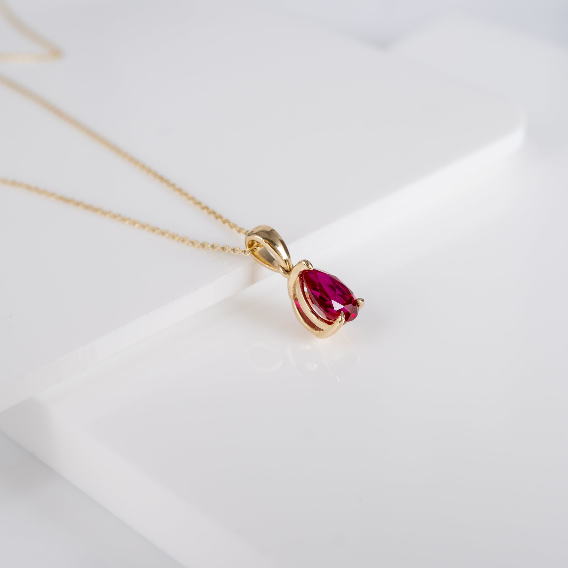 Ruby teardrop pendant necklace in 9ct yellow gold, showcasing lab-grown ruby with adjustable chain by Hunters Fine Jewellery.