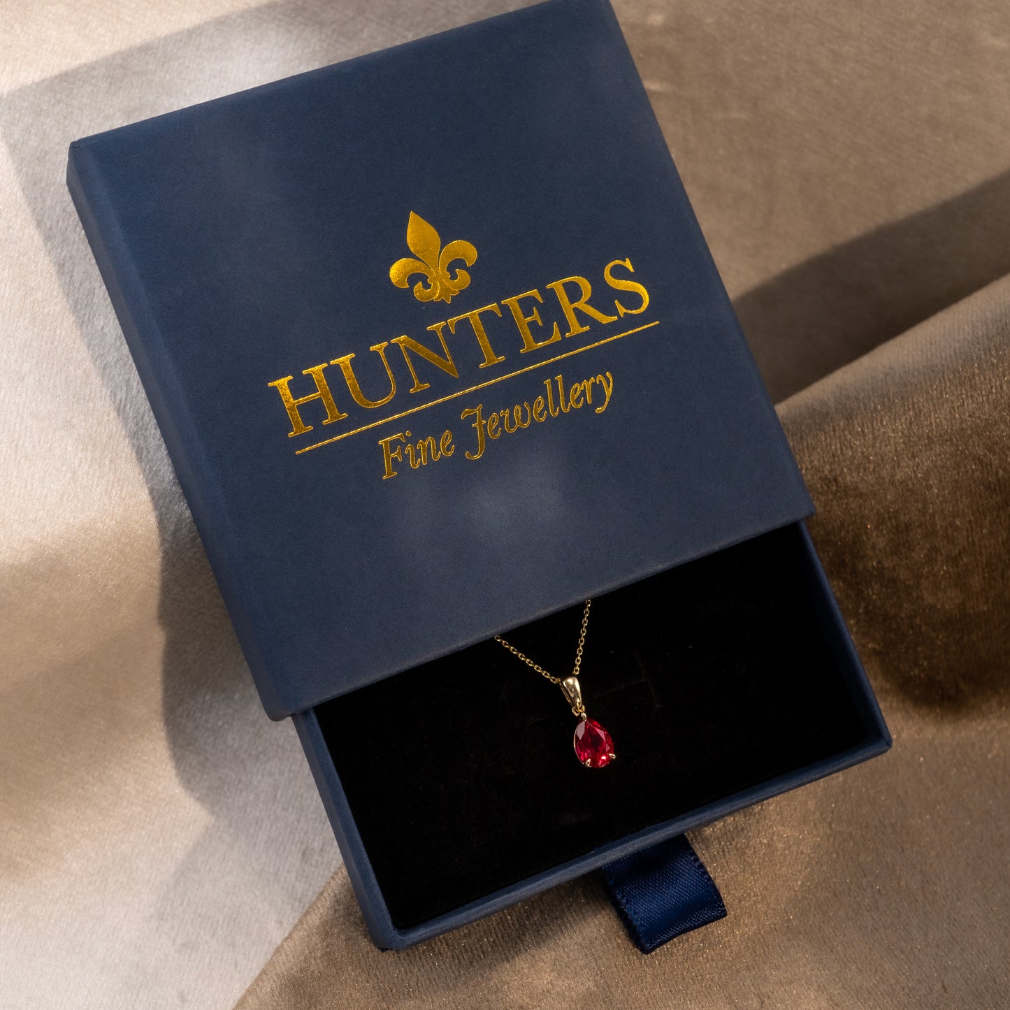 Ruby teardrop pendant necklace in Hunters Fine Jewellery branded box, featuring lab-grown ruby and yellow gold design.