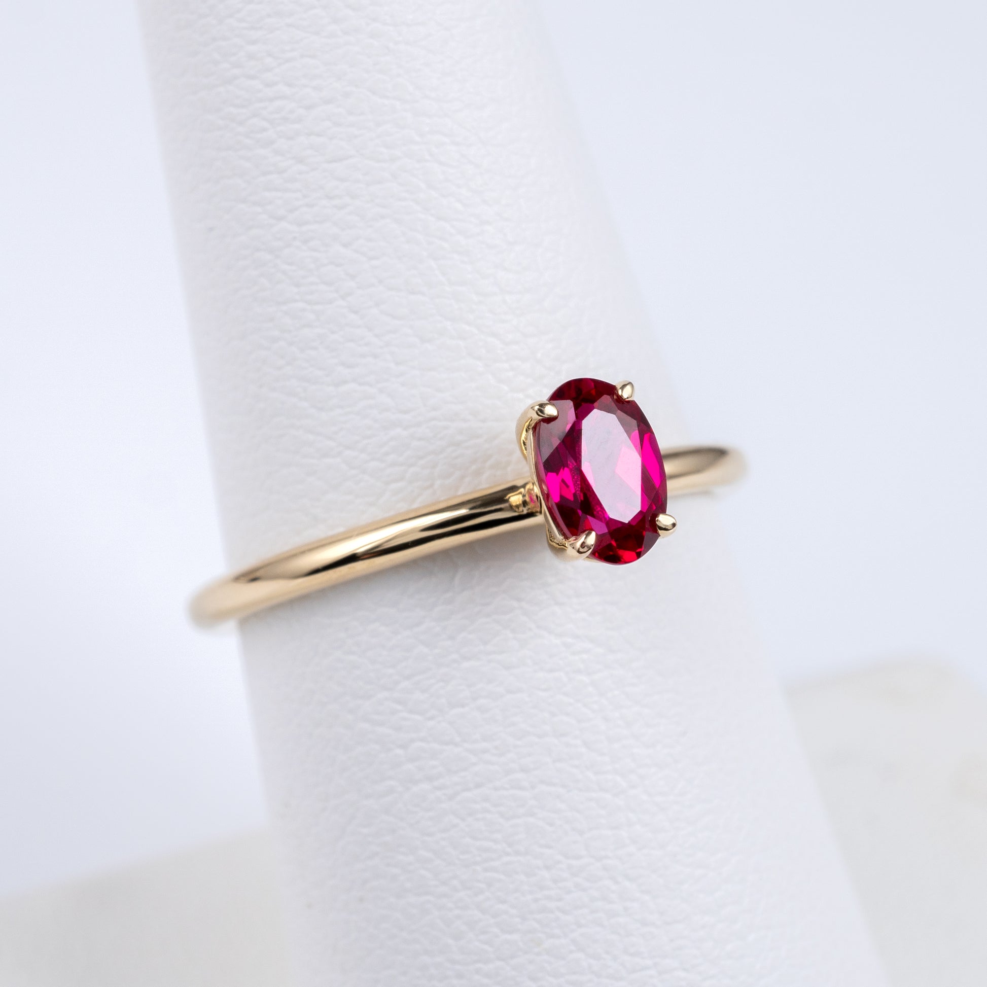 oval ruby solitaire ring yellow gold thin shank