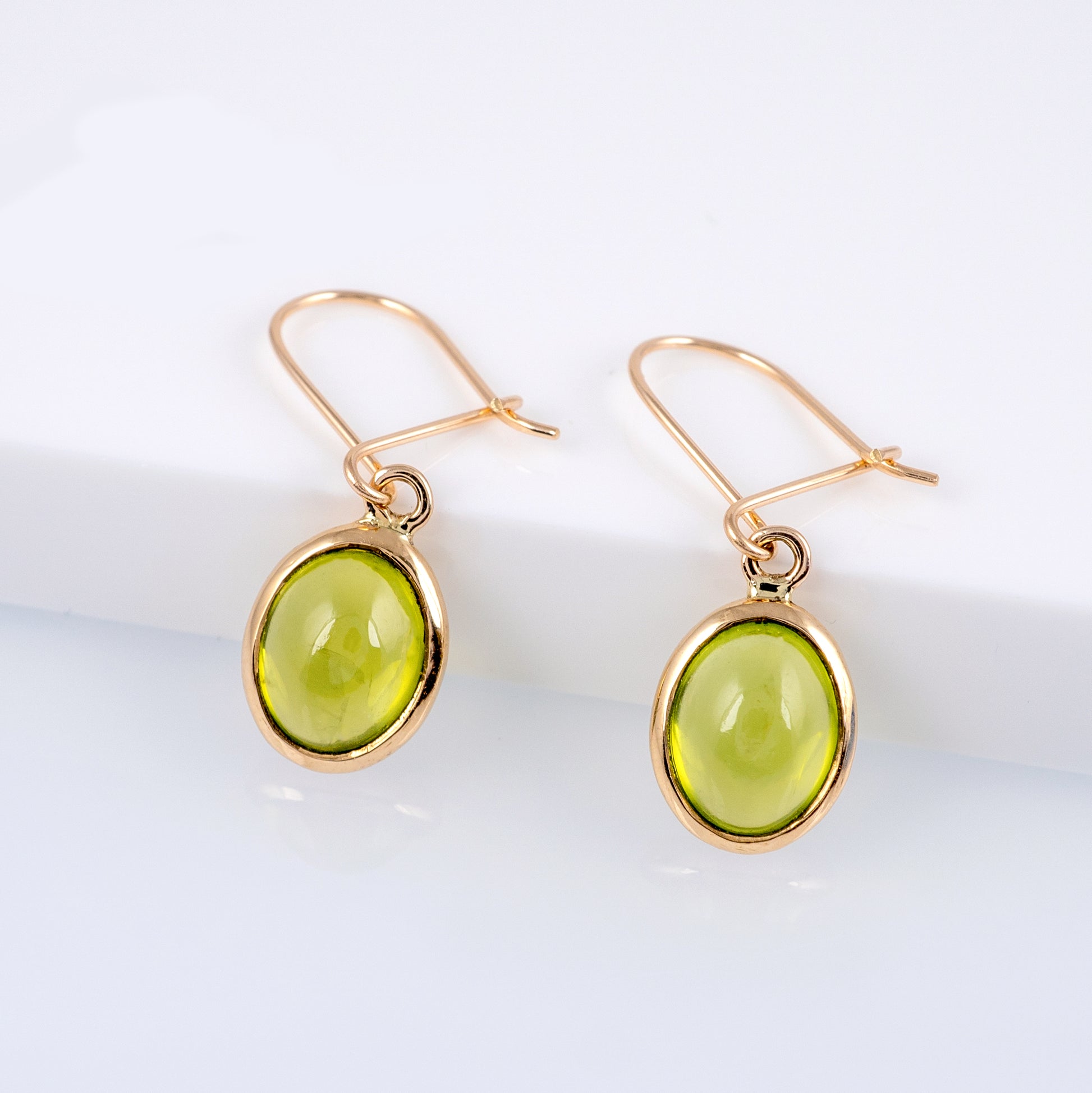 peridot dangle earrings yellow gold
